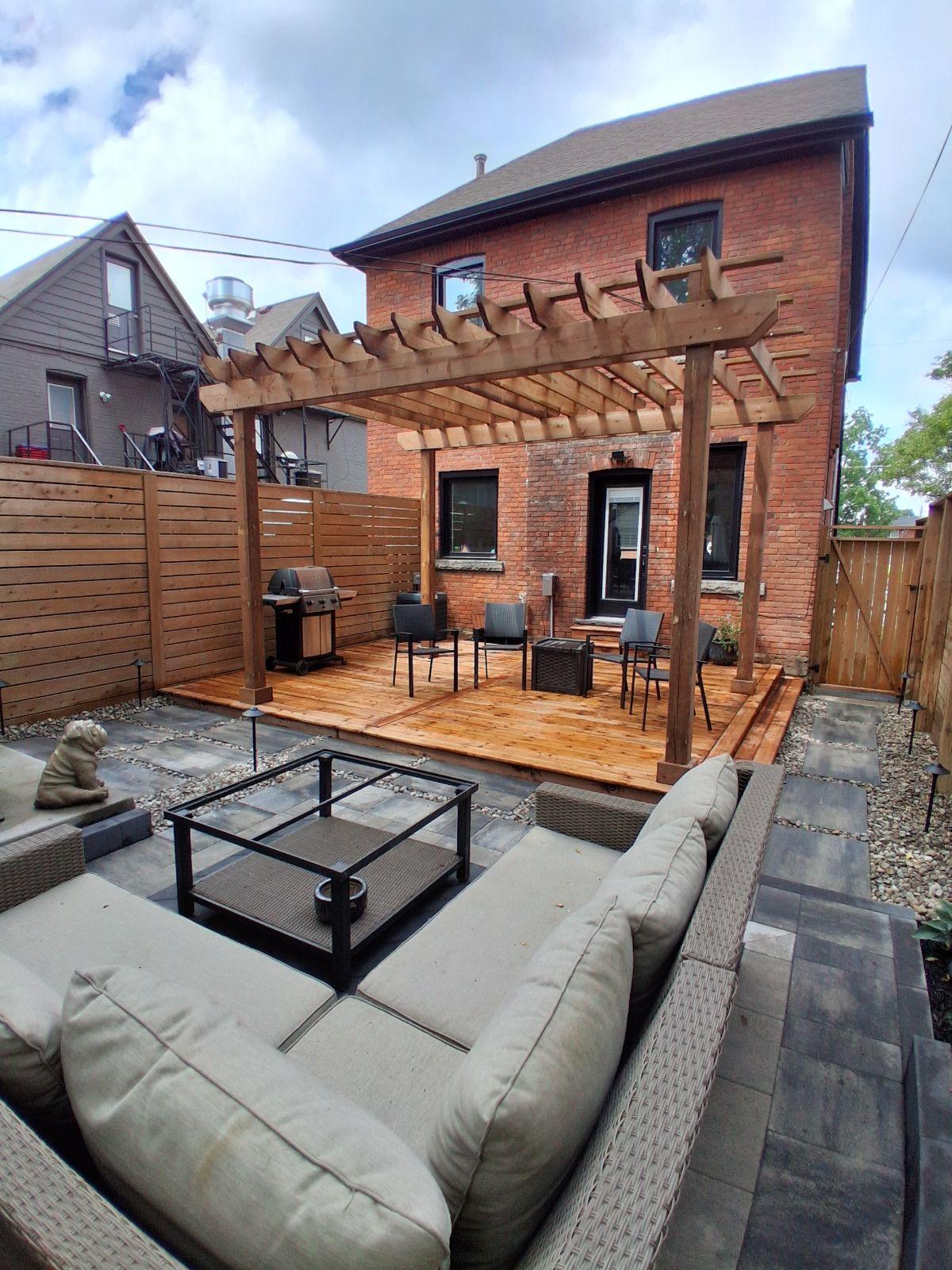 Backyard pergola with wood deck seating area